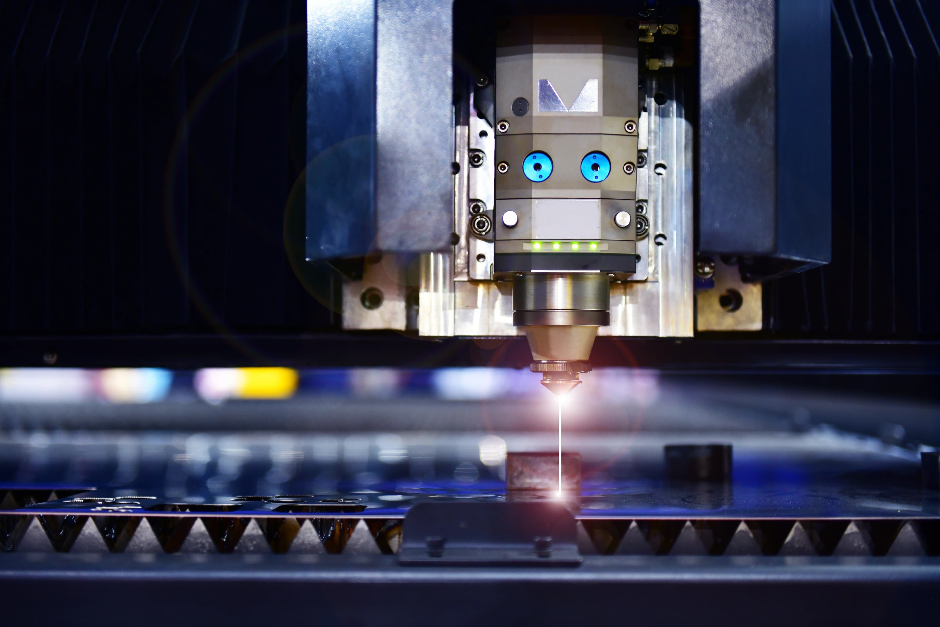 CNC laser cutting machine cutting through a piece of sheet metal